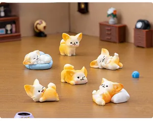 Detailed view of six miniature fennec fox resin figurines in various sleeping poses