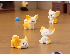 Macro detail of four resin fennec fox figurines in cute sitting and standing poses