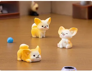 Detailed view of three miniature resin fennec fox figurines in a cozy dollhouse scene