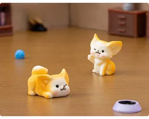 Detailed macro view of two cute yellow resin fennec fox figurines in a miniature room setup