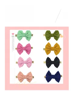 Detailed grid showing eight assorted waffle texture plaid bow headbands for babies