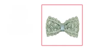 Détail d'une pince à cheveux à nœud en dentelle vert menthe aux textures ajourées
