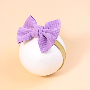 Soft purple waffle knit bow headband with elastic nylon strap for infants and toddlers