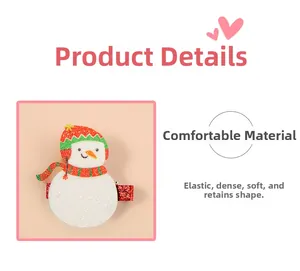 Detail of Christmas snowman hair clip with glitter material and red-green striped hat