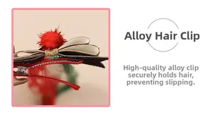 Detail view of a Christmas red hair clip with a plush ball and non-slip alloy duckbill clamp