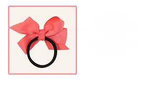 Macro detail of coral pink grosgrain ribbon bow with high-elastic black hair tie
