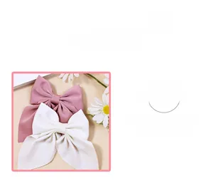 Détails de nœuds à cheveux en ruban rose et blanc montrant la texture et le drapé