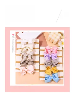 Detail showing nine colorful ribbon bow baby headbands on a display card for kids