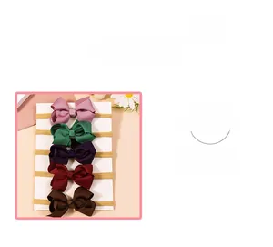 Detail of five-piece baby bow headband set in multi-color soft ribbed fabric