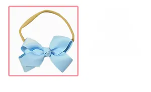 Close-up of baby elastic headband featuring a light blue ribbon bow with seamless beige band
