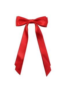 Detail of red satin ribbon bow hair clip with long streamers on white background