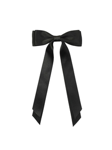 Detail shot of black satin bow hair clip with long ribbons and smooth silky texture