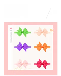 Detail view of colorful grosgrain ribbon bows on soft elastic nylon baby hairbands