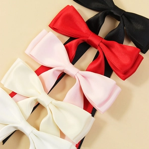 Elegant satin bow hair clips in assorted colors like black, white, and pink