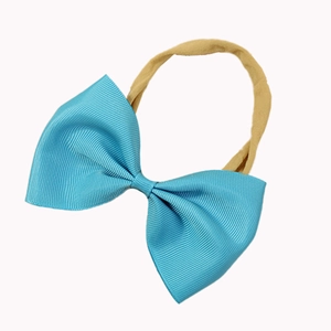 Close-up of light blue grosgrain ribbon bow with high elastic nylon headband for babies