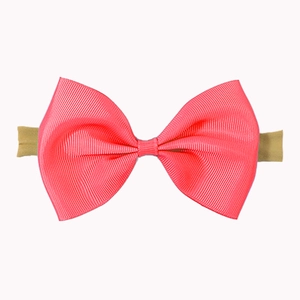 Detail of pink grosgrain ribbon bow on elastic nylon headband for babies and infants