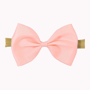 Detailed macro view of pink grosgrain bow hair band with elastic tie for baby girls