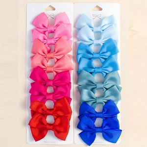 Vue détaillée du lot de 20 barrettes noeuds en ruban gros-grain aux couleurs variées