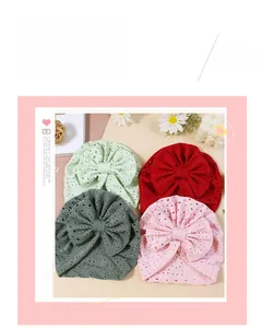 Detail of four breathable cotton baby headbands with large bows in varied soft colors