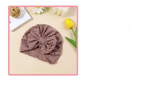 Detail of baby turban hat with oversized bow in vintage dusty rose eyelet lace fabric
