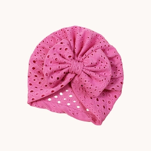 Soft peach pink baby turban hat with delicate embroidery and large bow decoration