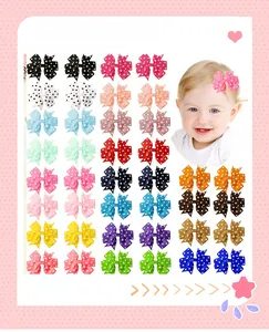 Detailed collection of 14 colorful polka dot ribbon hair clips for little girls