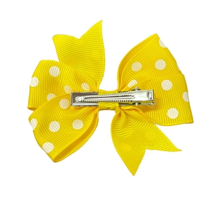 Handmade yellow polka dot bow hair clip with a secure silver metal alligator clip