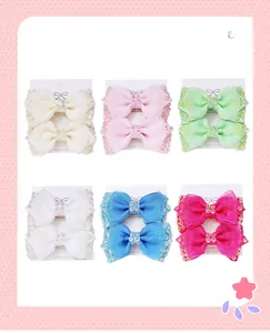 Detail view of handmade mesh bow hair clips with rhinestones in six various colors