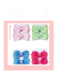 Detail view of handmade mesh bow hair clips with sequins and pearls in four bright colors