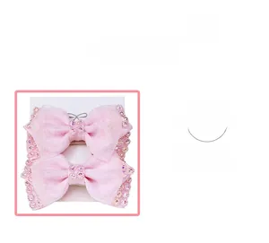 Detail shot of pink ribbon hair clips with sparkling rhinestones and mesh texture