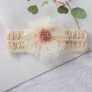 Close-up of baby headband with cream crochet elastic band and large tulle flower detail