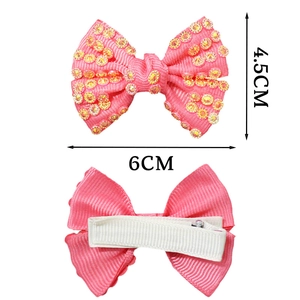 Pink ribbon bow hair clip for girls with yellow rhinestones and white mesh details