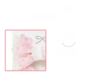 Detail of pink bow hair clip with colorful rhinestones and white pearls on a display card