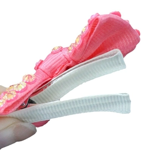 Pink ribbon hair clip with yellow rhinestones and white non-slip fabric lining