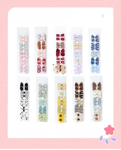 Detailed grid of assorted fabric bow hair clips with floral patterns and textures