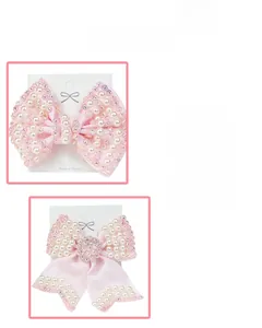 Detail view of pink ribbon hair bow clips with white pearls and sparkling rhinestones