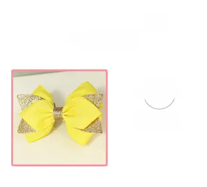 Vue détaillée du nœud à cheveux jaune vif avec des accents dorés scintillants et tissu texturé
