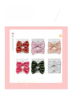 Close-up of handmade ribbon bow hair clips with colorful rhinestones in six bright colors