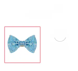 Detail of light blue bow hair clip featuring shiny rhinestones and metal clip structure