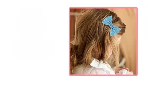 Detailed view of light blue lace bow hair clip with sequins and beads for children