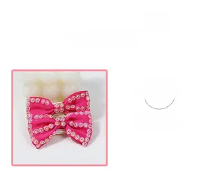 Detail of pink bow hair clip with gradient rhinestones and premium ribbed ribbon texture