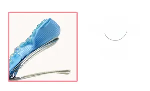 Detailed macro view of a blue grosgrain ribbon wrapped duckbill hair clip with small beads