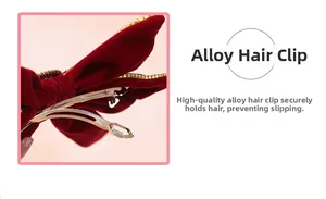 Detail of red velvet bow hair clip with sparkling rhinestones and golden alloy spring clip
