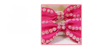 Detail of handmade pink grosgrain ribbon bow hair clip with sparkling aurora rhinestones