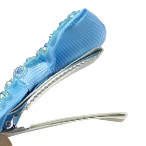 Handmade light blue ribbon bow hair clip with colorful rhinestones on a metal duckbill clip