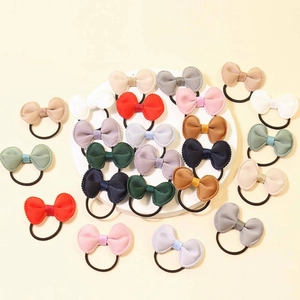 Set of colorful handmade mini bow hair ties with elastic bands in various soft shades