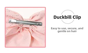 Detail view of pink chiffon bow hair clip showing secure silver metal alligator clip back