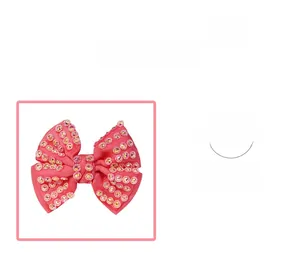 Detail of rose pink ribbon bow hair clip with sparkling rhinestones and duckbill clip