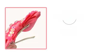 Detailed view of pink grosgrain bow hair clip with colorful rhinestones and lined metal clip