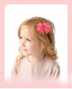 Detailed view of a handmade rose pink ribbed grosgrain ribbon hair bow worn by a girl